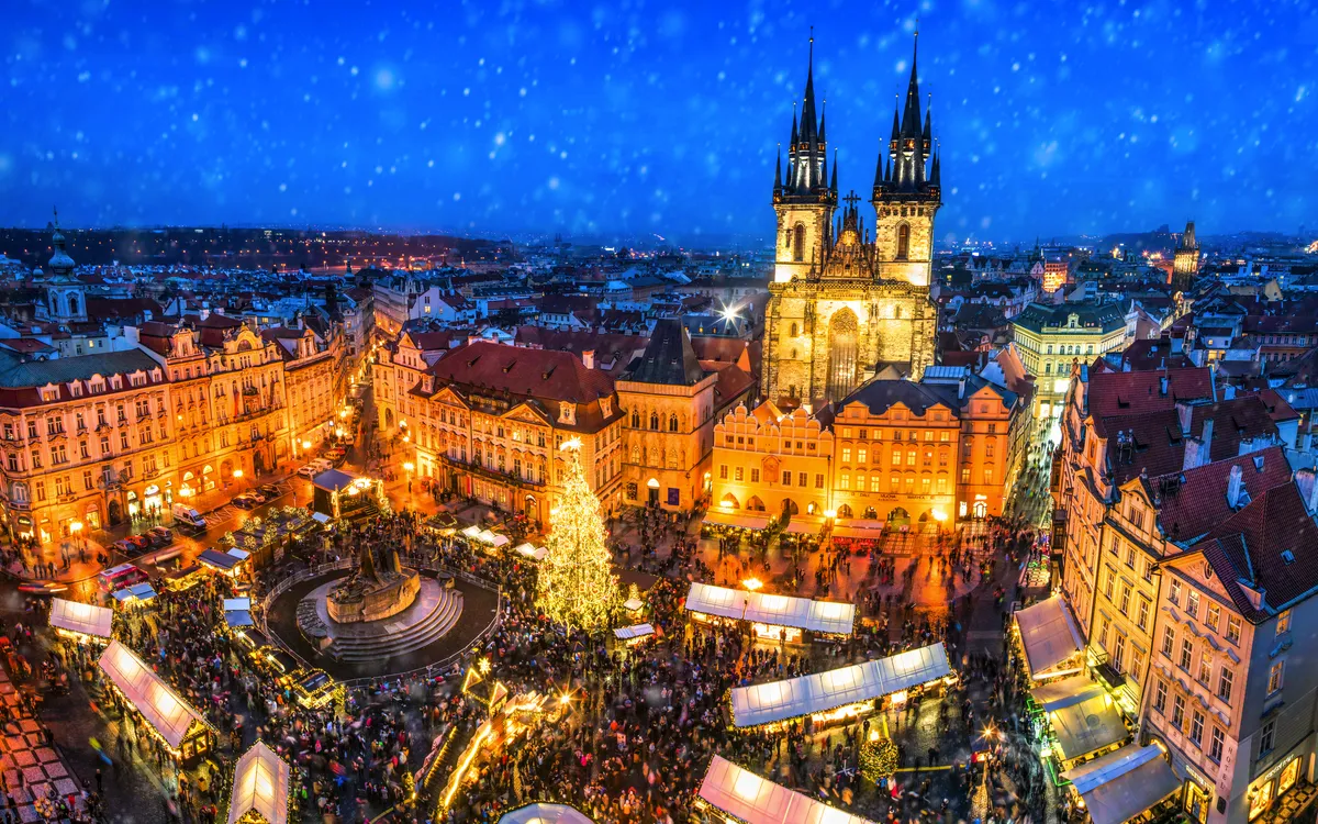 Weihnachtsmarkt am Altstädter Ring in Prag bei Nacht mit Teynkirche im Hintergrund