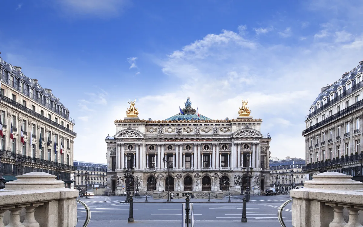 Historisches Gebäude mit verzierten Fassaden und blauen Himmel im Hintergrund.