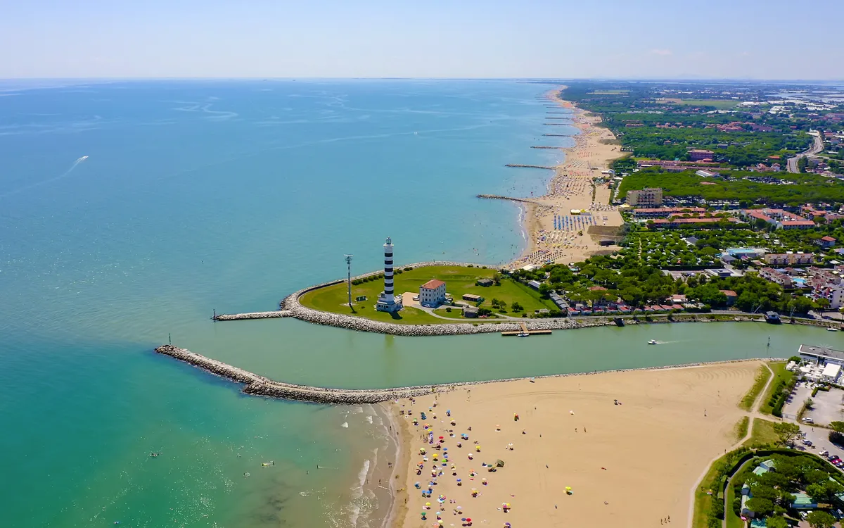 Strand mit Sanddünen und Küstenlinie aus der Vogelperspektive.