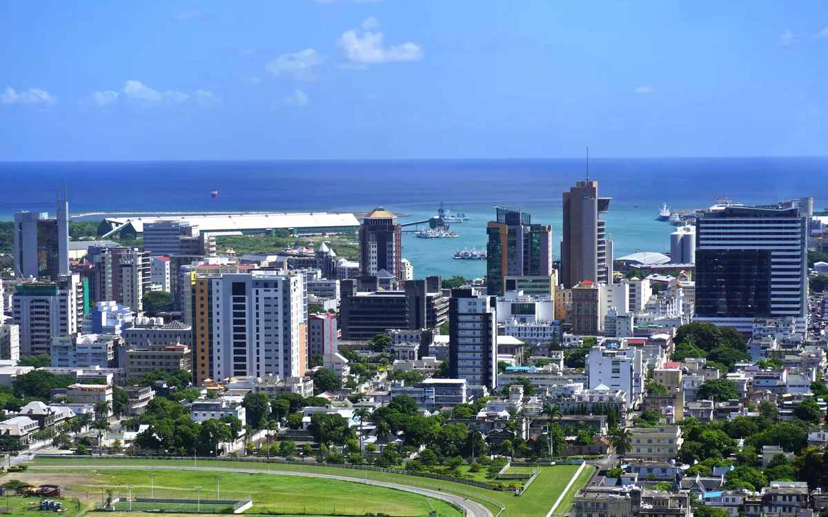 Blick auf Port Louis, Mauritius mit Hochhäusern und Meer im Hintergrund.