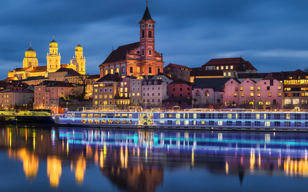 Dreiflüssestadt Passau im Winter bei Abenddämmerung mit Blick auf die Altstadt und den Fluss.
